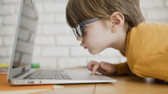 side-view-child-with-glasses-getting-too-close-see-laptop_23-2148524697